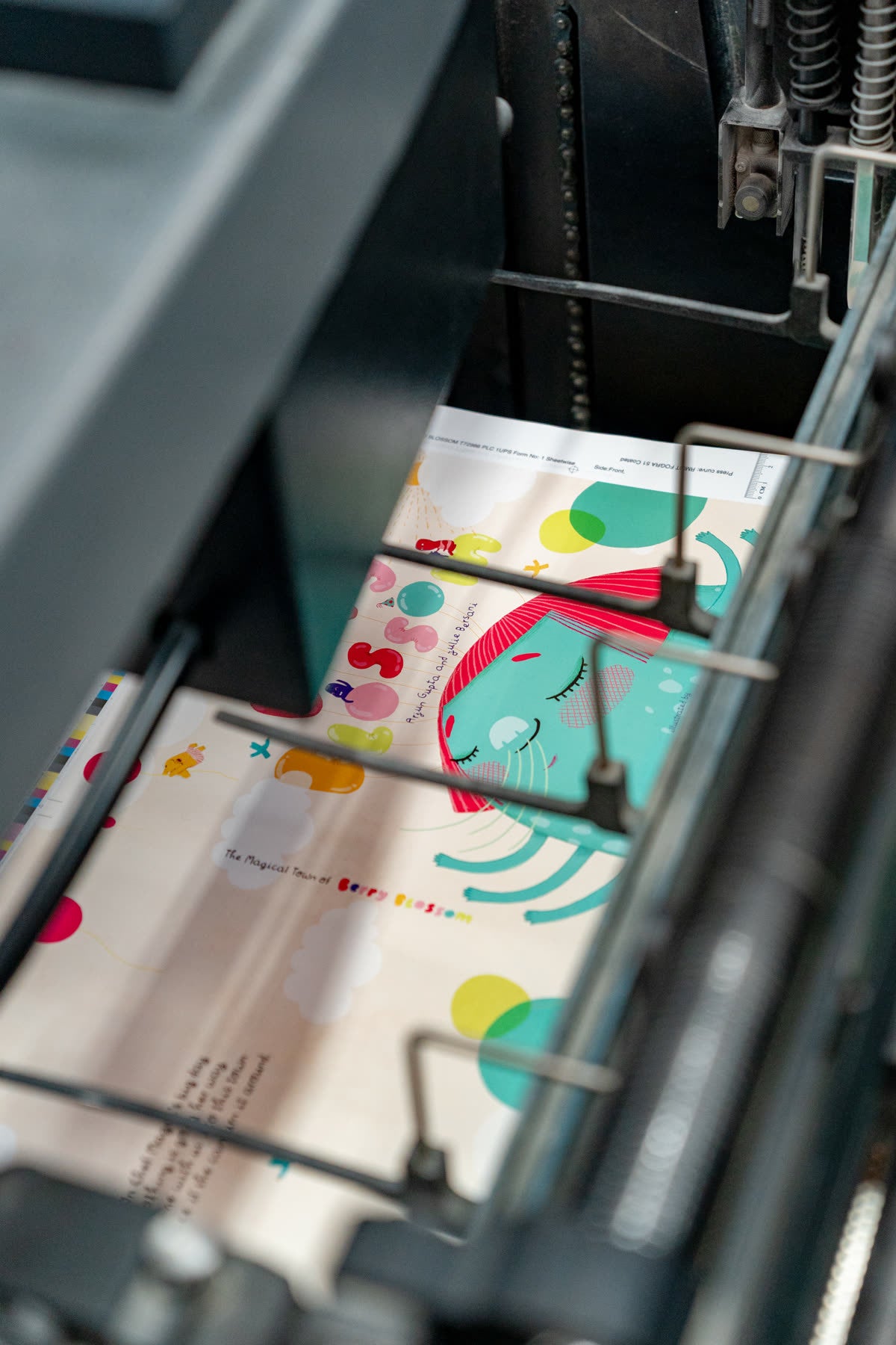 Printed sheets of Berry Blossom moving through the press